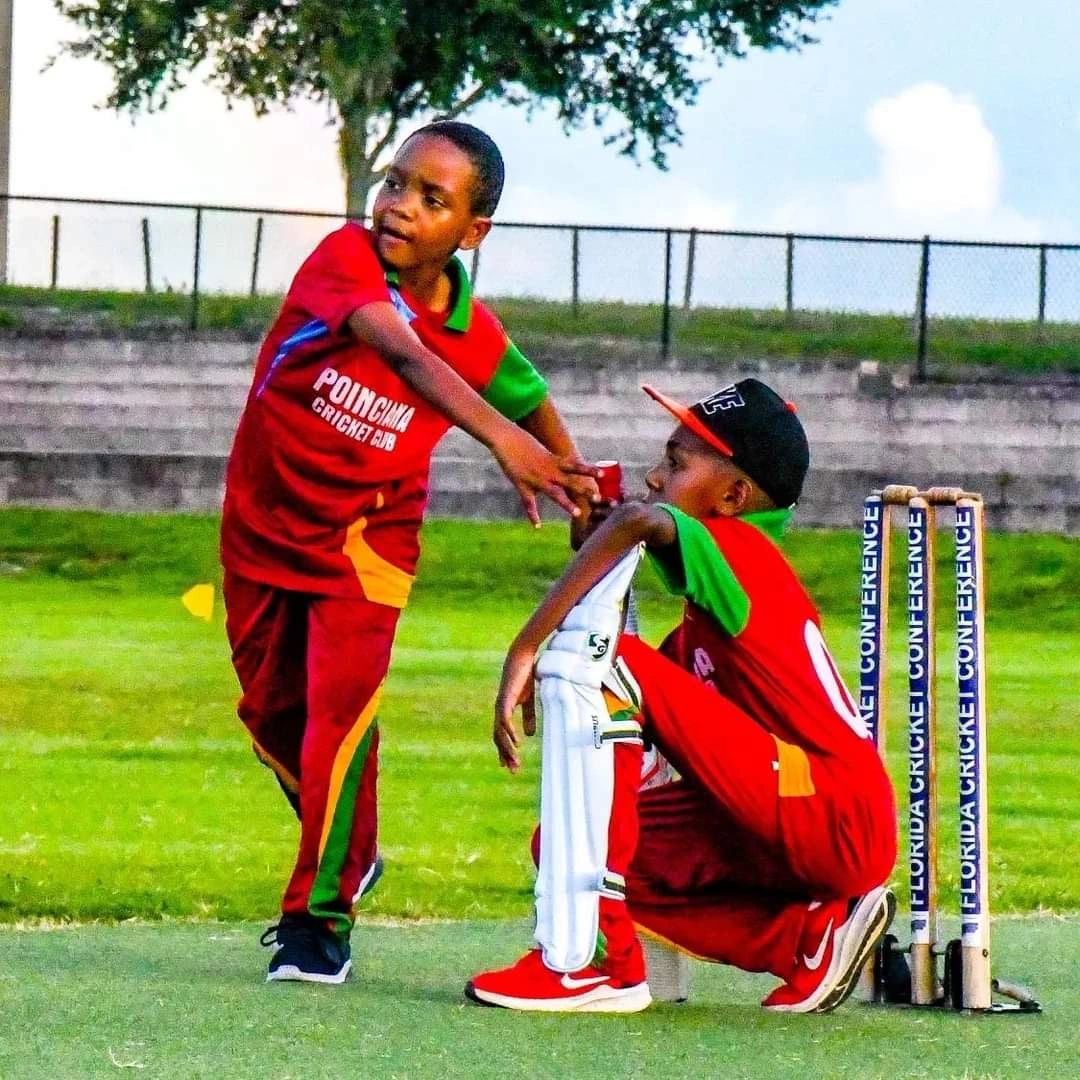 Two young cricketers, one consoling the other
